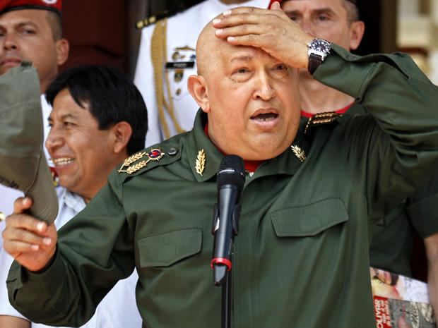 Venezuelan President Hugo Chavez takes his cap off during a welcoming ceremony for Bolivian President Evo Morales at the Miraflores presidential palace in Caracas, Venezuela, Sept. 17, 2011. 
