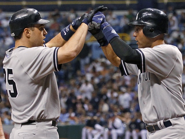 Mark Teixeira is congratulated by Derek Jeter after his grand slam  
