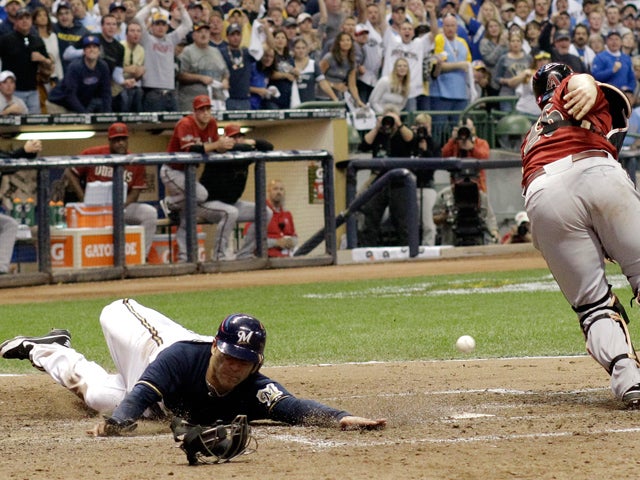 Miguel Montero can't catch the throw as Jerry Hairston Jr. scores  