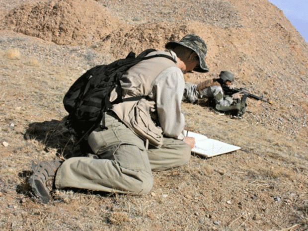 Artist Victor Juhasz sketches a training exercise. 