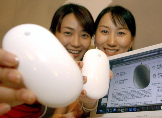 Women display new Apple Computer mouses 