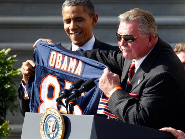 Head coach Mike Ditka presesnts President Barack Obama with a jersey as the 1985 Super Bowl XX Champions Chicago Bears football team are honored on the South Lawn of the White House in Washington, Friday, Oct. 7, 2011. 