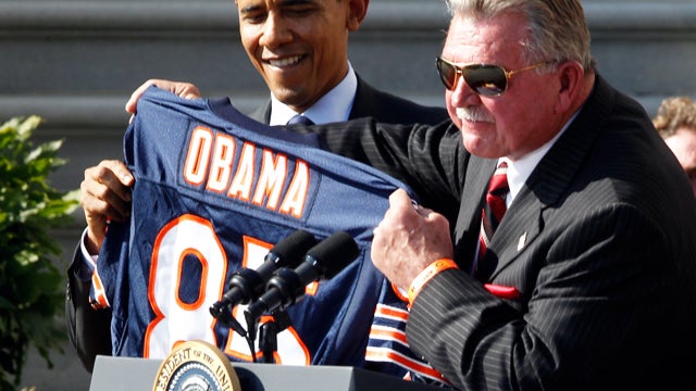 Head coach Mike Ditka presesnts President Barack Obama with a jersey as the 1985 Super Bowl XX Champions Chicago Bears football team are honored on the South Lawn of the White House in Washington, Friday, Oct. 7, 2011. 