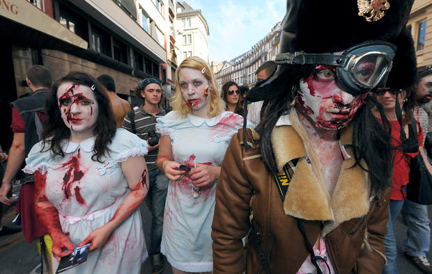 People dressed as zombies take part in t 