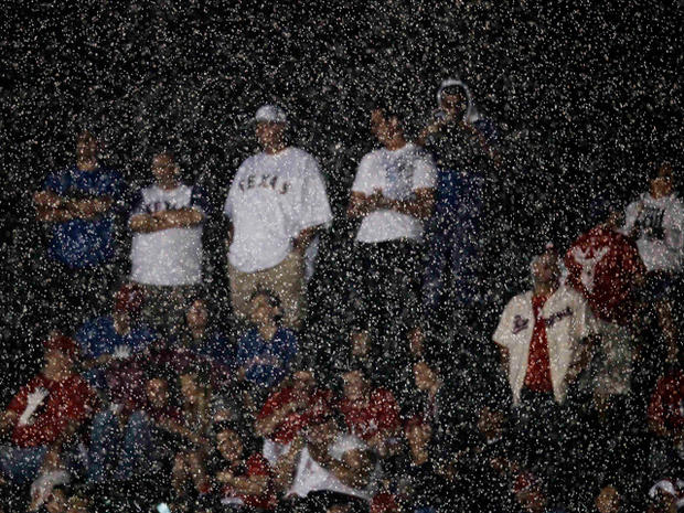 Fans wait through a rain delay  