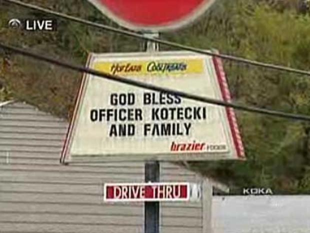 officerkotecki_dq-sign.jpg 