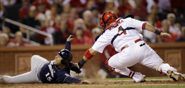 Jerry Hairston Jr. slides safely past Yadier Molina 