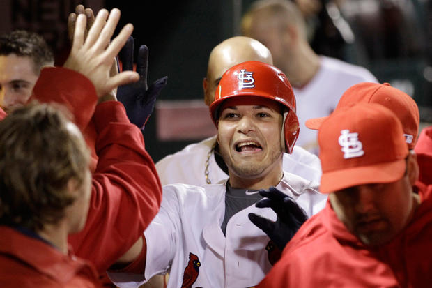 Yadier Molina is congratulated in the dugout after scoring 