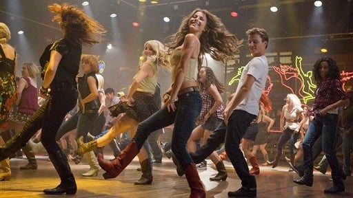 In this image released by Paramount Pictures, Julianne Hough, center, and Kenny Wormald are shown in a scene from "Footloose." The robot boxers of "Real Steel" and the dancers of "Footloose" are in a tight fight for the box-office title. "Real Steel" came 