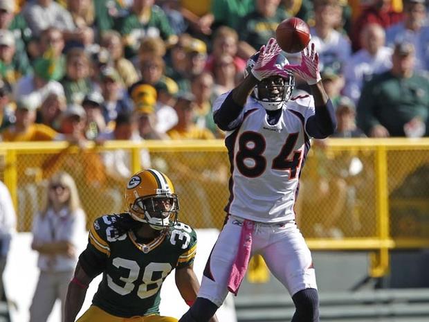 GREEN BAY, WI - OCTOBER 2: Brandon Lloyd #84 of the Denver Broncos makes a catch while being covered by Tramon Williams #38 of the Green Bay Packers at Lambeau Field on October 2, 2011 in Green Bay, Wisconsin. (Photo by Matt Ludtke /Getty Images) 