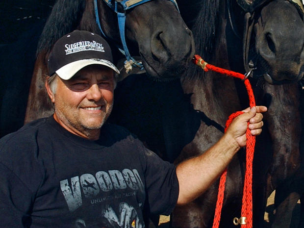 In an Aug. 2008 photo, Terry Thompson stands with some of his award-winning Percheron horses on his farm west of Zanesville, Ohio. Authorities said Thompson, a game-preserve owner, apparently freed dozens of wild animals, including tigers and grizzly bears, and then killed himself Tuesday night, Oct. 18, 2011. 