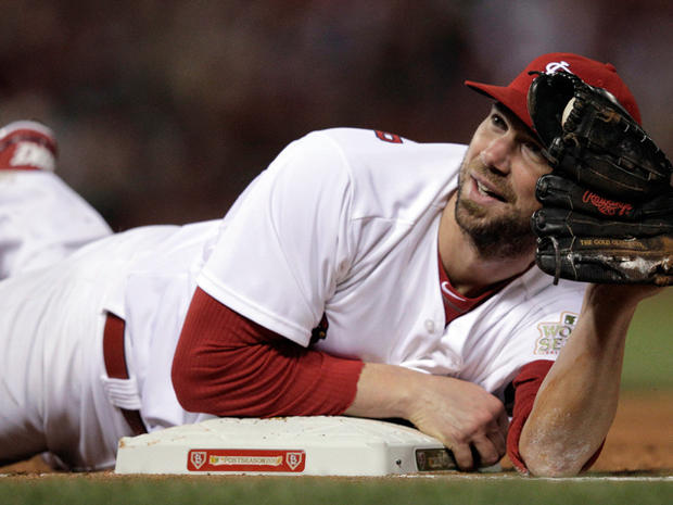 Chris Carpenter looks up after diving to tag first base 