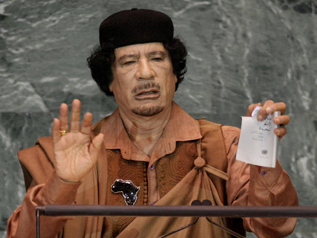 Moammar Qaddafi shows a torn copy of the UN Charter 