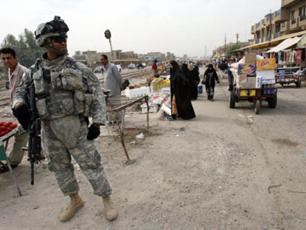 A US soldier patrols a popular market in 