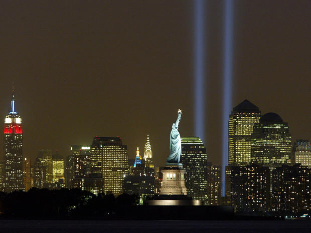 Beams of light shine into the sky behind the Statue of Liberty and above the Manhattan skyline Sept. 11, 2003. The lights pay tribute to those who lost their lives when the World Trade Center was attacked in 2001. 