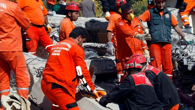 Rescuers work to save people from debris of collapsed buildings in Ercis, Turkey, Oct. 24, 2011. At least 270 people were killed after a powerful quake in eastern Turkey and dozens of people are still trapped in hills of debris, but authorities hope the d 
