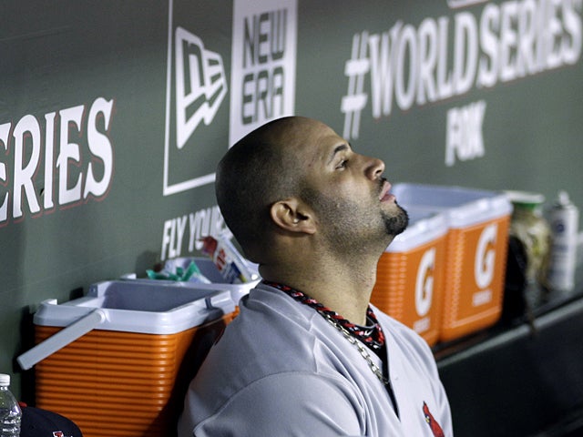 Albert Pujols sits in the dugout 