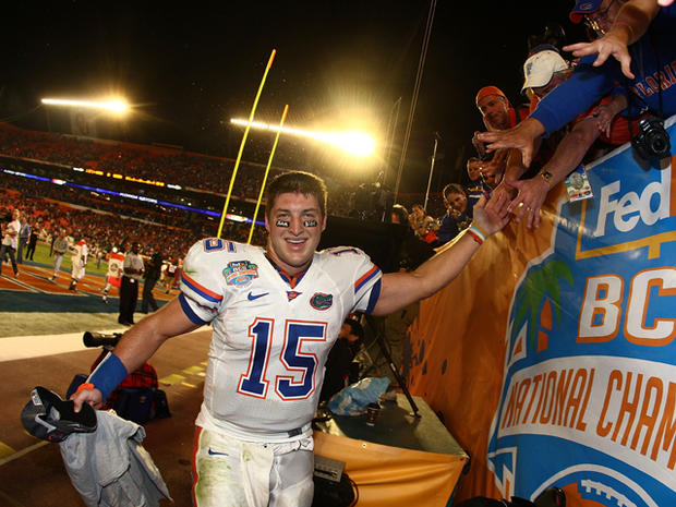 Tim Tebow celebrates with fans  