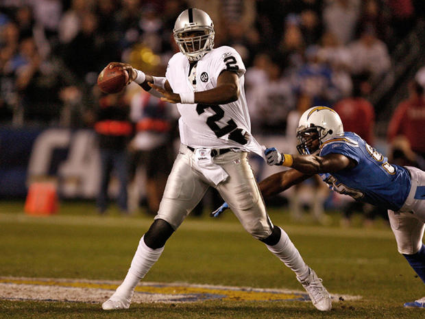 JaMarcus Russell is grabbed by linebacker Shaun Philips 
