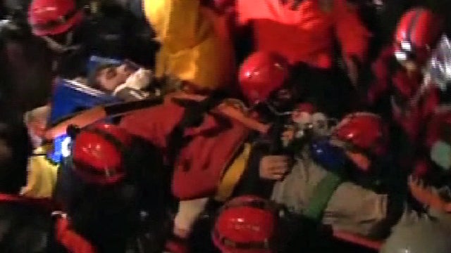 Rescuers tend to a man pulled from under rubble in Ercis, Turkey, Oct. 27, 2011, 100 hours after a 7.2-magnitude earthquake struck the eastern part of the country. 