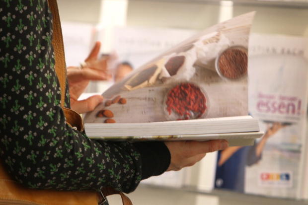 A woman reads a cookbook 