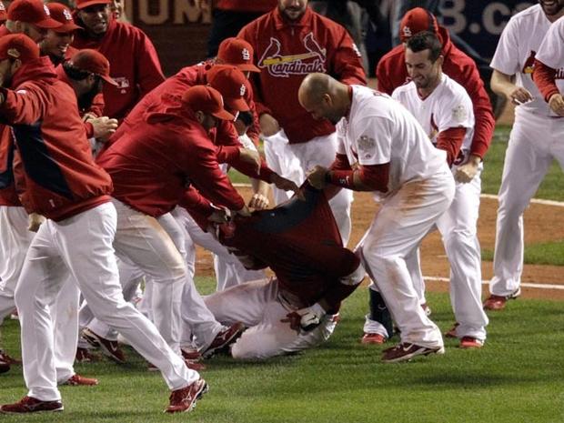ST LOUIS, MO - OCTOBER 27: The St. Louis Cardinals bench rip the jersey shirt off of David Freese #23 after hitting a walk off solo home run in the 11th inning to win Game Six of the MLB World Series against the Texas Rangers at Busch Stadium on October 27, 2011 in St Louis, Missouri. The Cardinals won 10-9. (Photo by Rob Carr/Getty Images) 