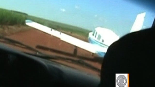 Scene from dashcam of police cruiser in Brazil that was about to ram the wing of the plane seen in the image, taken from video 