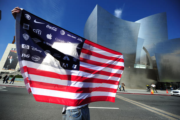 An Occupy LA protestor holds a US flag w 