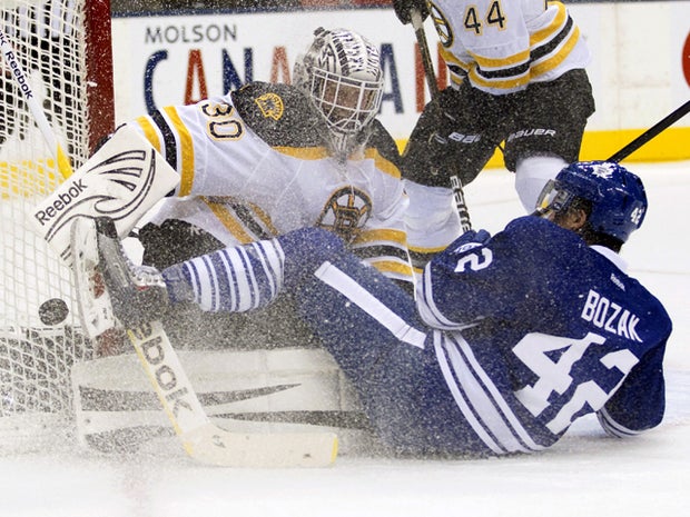 Tyler Bozak crashes into Tim Thomas 