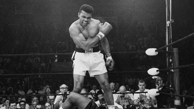 Muhammad Ali stands over Sonny Liston 