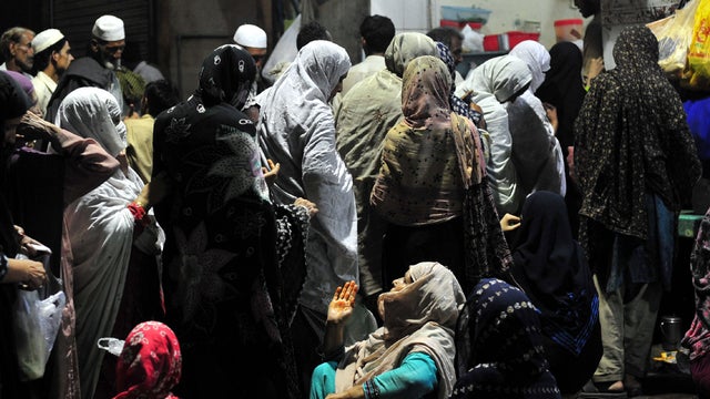 Impoverished Pakistanis line up to get free food at a restaurant in Rawalpindi Aug. 21, 2011. 