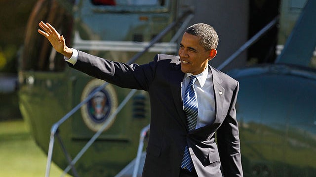 U.S. President Barack Obama waves to guests after arriving on the South Lawn of the White House November 8, 2011 in Washington, DC.  