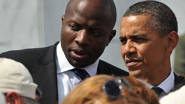 U.S. President Barack Obama listens to his personal assistant Reggie Love as he greets family members of victims aboard United flight 93 on September 11, in Shanksville, Pennsylvania.  