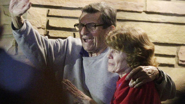 Joe Paterno and his, wife, Susan, stand on their porch to thank supporters 