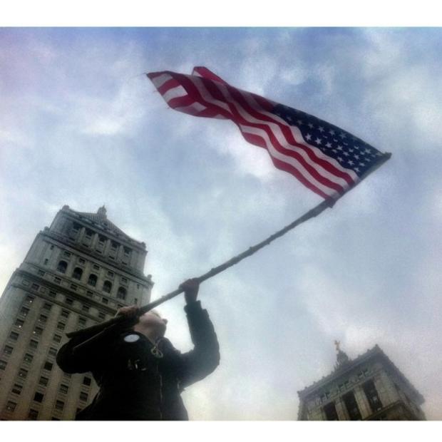 A protester waving the American flag  at Foley Square 