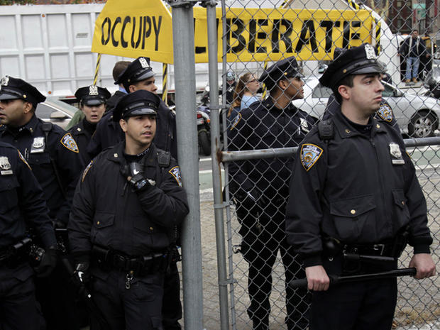 Police officers watch over an Occupy Wall Street rally  