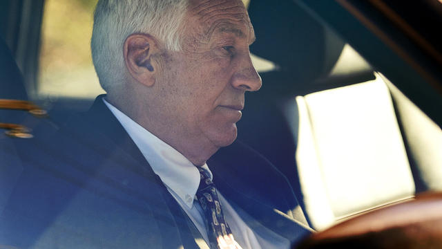 Former Penn State football defensive coordinator Gerald "Jerry" Sandusky sits in a car as he leaves the office of Centre County Magisterial District Judge Leslie A. Dutchcot Nov. 5, 2011, in State College, Pa. Sandusky is charged with sexually abusing eig 