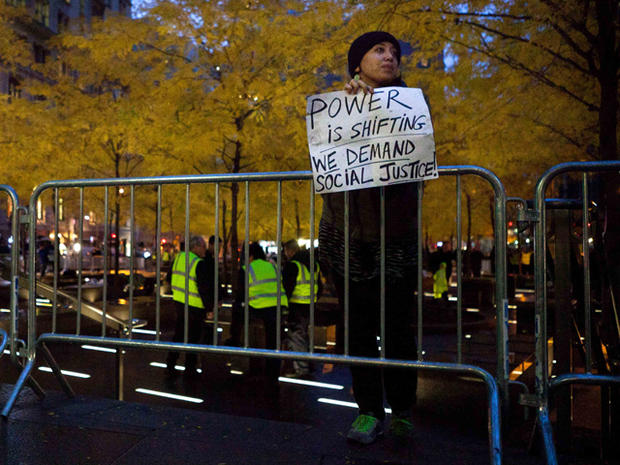 Occupy Wall Street protestor holds a sign 