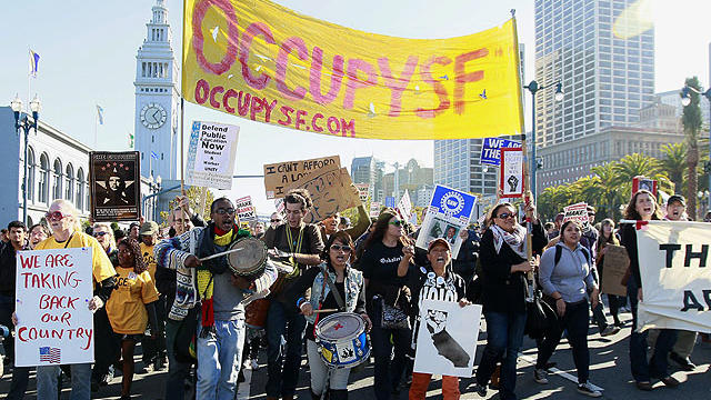Students from University of California at Berkeley and other California colleges and Occupy San Francisco protesters march along the Embarcadero as part of a demonstration in San Francisco, Nov. 16, 2011.  