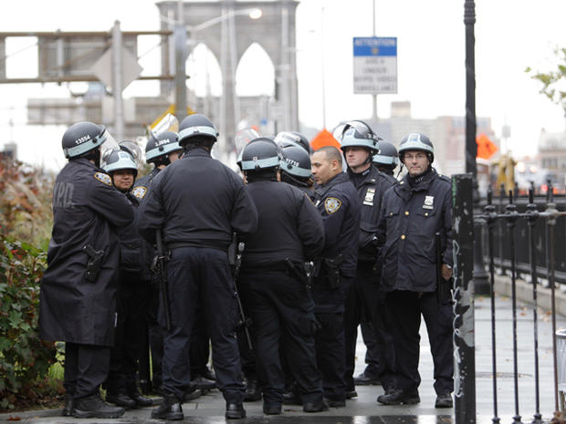 Police officers in riot gear gather at the entrance to the Brooklyn Bridge prior to a march planned by demonstrators affiliated with the Occupy Wall Street movement Nov. 17, 2011, in New York. 