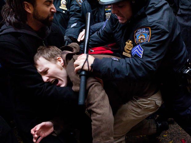 An Occupy Wall Street protester is grabbed by police as he tries to escape a scuffle in Zuccotti Park Nov. 17, 2011, in New York. 