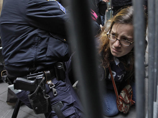A police officer arrests a demonstrator affiliated with the Occupy Wall Street movement as protesters block the entrance to the New York Stock Exchange on Broad Street Nov. 17, 2011, in New York. Hundreds of protesters attempted to shut down the New York  
