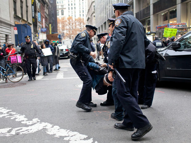 A protester affiliated with the Occupy Wall Street movement is arrested by police officers on Beaver Street in New York's financial district Nov. 17, 2011. 