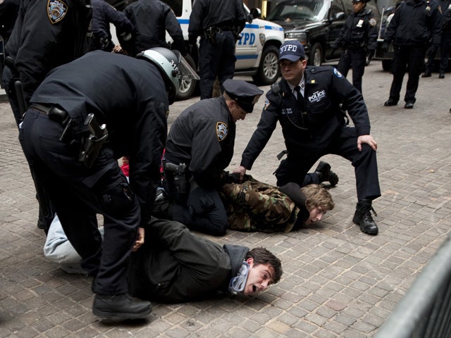 Occupy Wall Street protesters are arrested by police after blocking access to the New York Stock Exchange area Nov. 17, 2011, in New York. 
