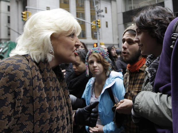 A woman argues with demonstrators affiliated with the Occupy Wall Street movement as they lock arms to block Broad Street Nov. 17, 2011, in New York. 