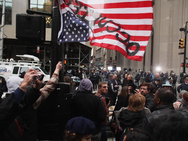 Protesters stand across from Wall Street  