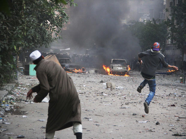 protesters throw rocks toward Egyptian riot police 