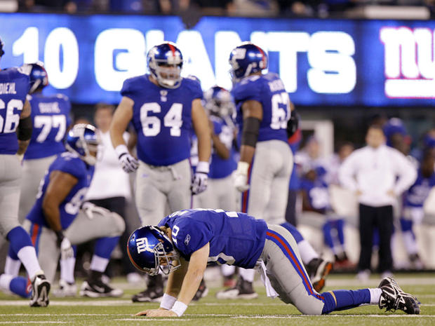 Eli Manning reacts after being sacked 