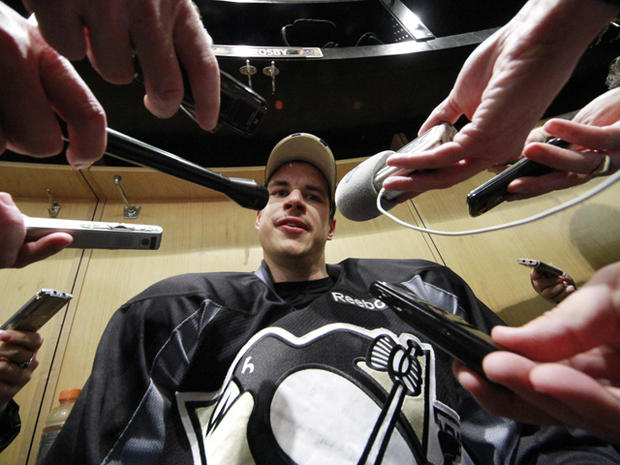 Sidney Crosby is surrounded by reporters  