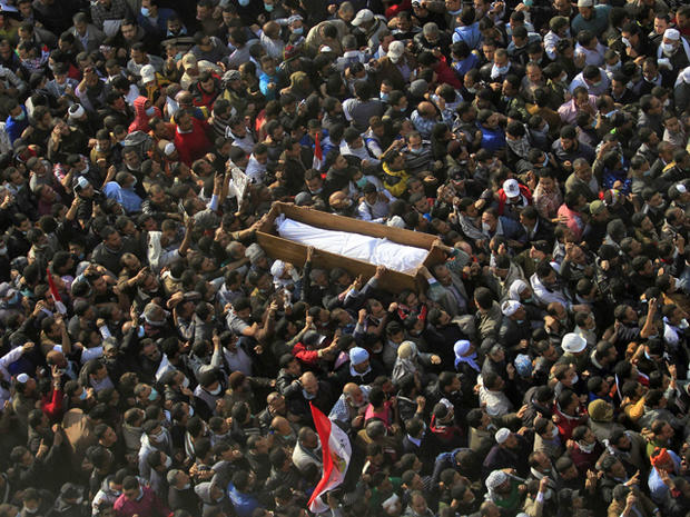 Egyptians carry a body of a protester was killed in clashes with police 